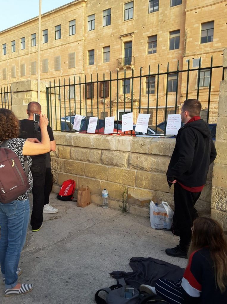 People protesting outside Identity Malta's offices this month 