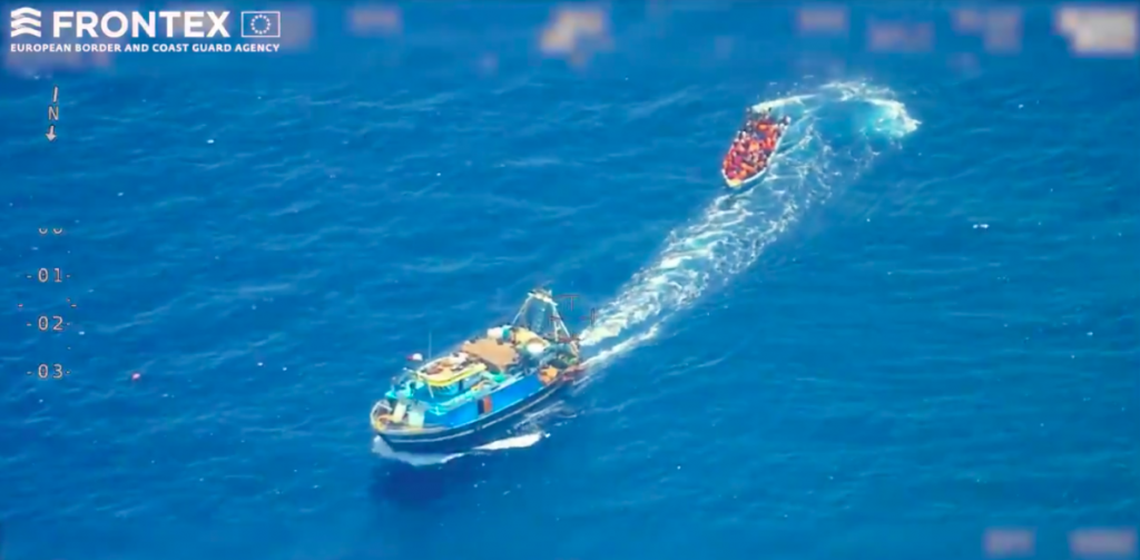 watch: smugglers tow seemingly empty wooden boat towards