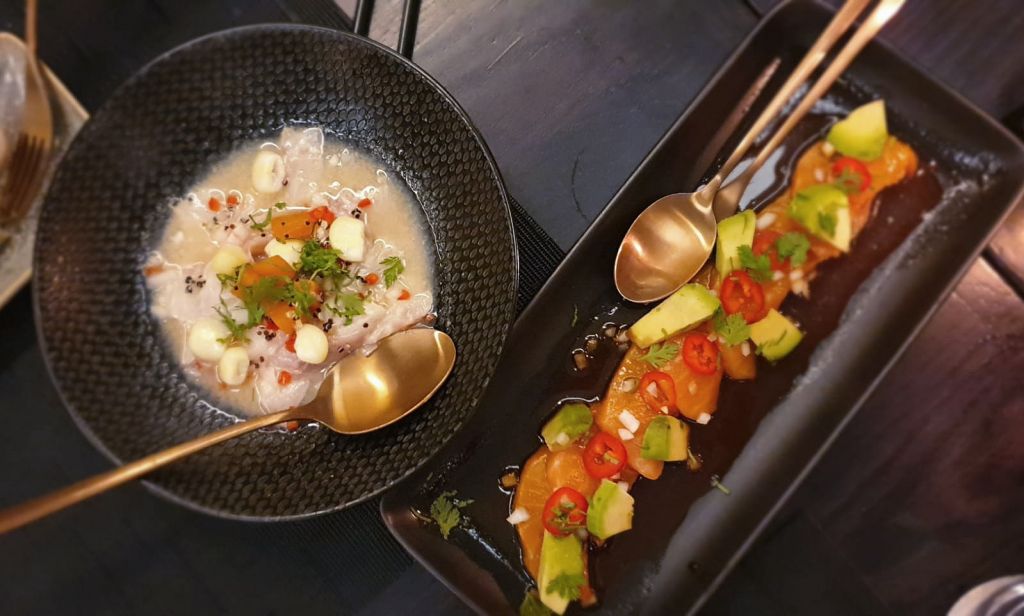 Zest Signature Sea Bass Ceviche, Quinoa, fresh Lime and charred White Corn & Nikkei Salmon Tiraditos with a Sesame and Soy dressing and Chipotle Paste