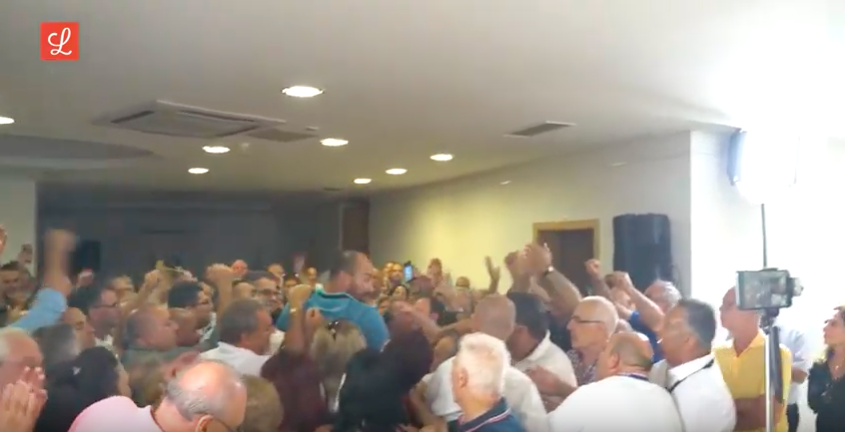 Adrian Delia's supporters mob the PN leader after he wins a confidence vote 