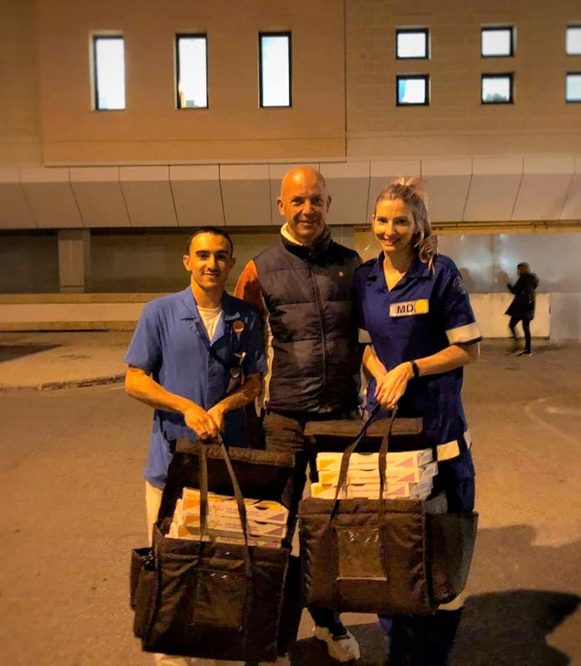 Some very tired frontliners receiving pizza at the end of their shift to help them through the night 