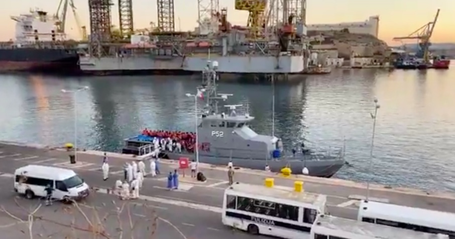 A group of 94 rescued migrants arrive in Isla, just before being instantly tested and isolated. Sreenshot from a NET News Live video