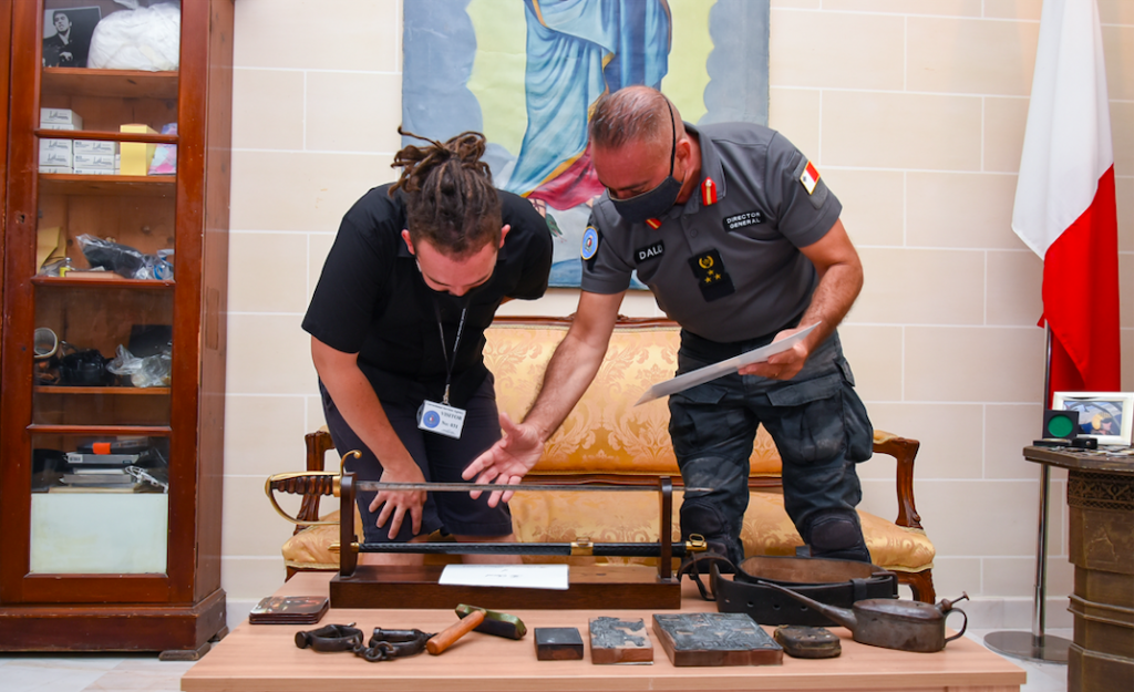 Dalli showcasing some antique Maltese prison artefacts that he restored 