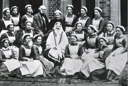 Florence Nightingale posing with her class of nurses from St. Thomas' Hospital, set up in 1860.