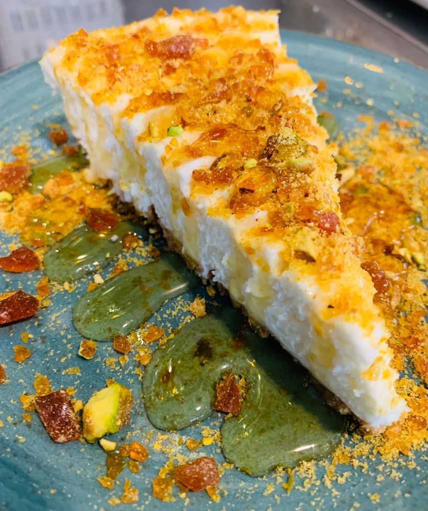 Greek yogurt cheesecake covered with pistachios and honey