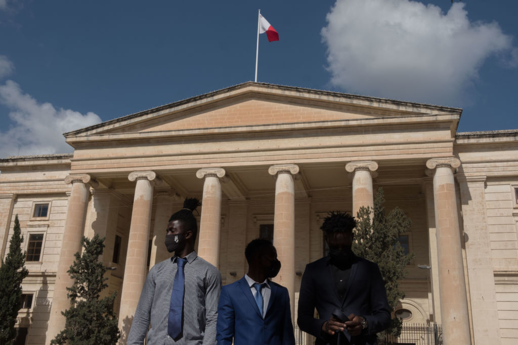 Abdul, Abdalla and Lamin standing outside of court