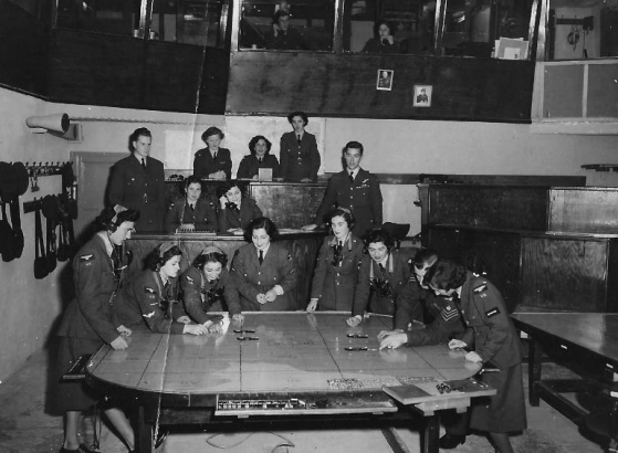 Rita Vella (Right, 3rd front row) in the plotter room in the 1950’s